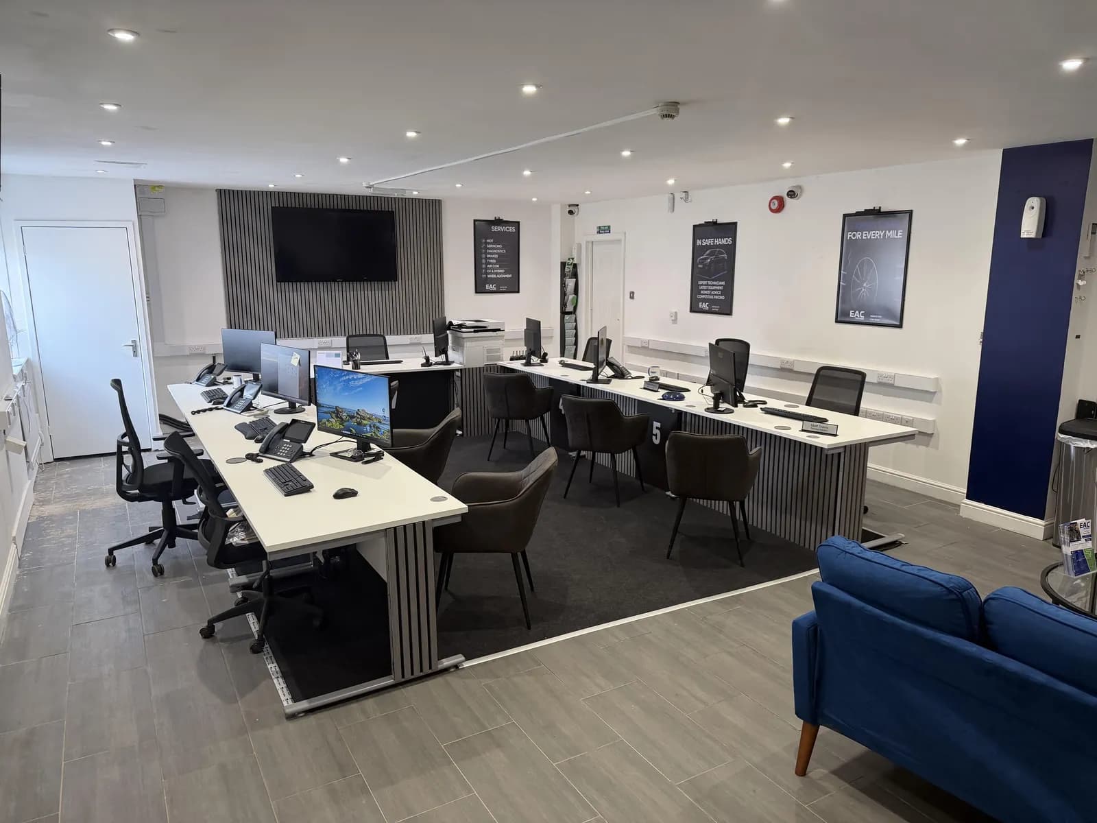 The open-plan office at EAC Telford with desks, screens and phones